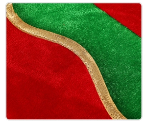 Detailed view of red and green velvet fabric with golden trim for Christmas elf hats