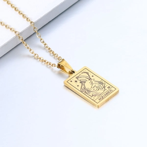 Detailed close-up of gold Aquarius pendant necklace with minimalist engraving design