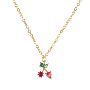 Close-up of gold cherry pendant with red heart gemstone and green leaf crystal