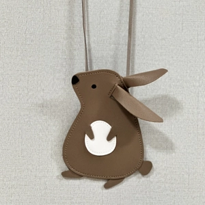 Detailed view of the rabbit-shaped crossbody bag with brown texture and cute long ears