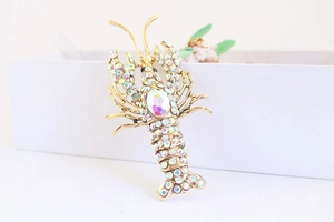 Macro view of crystal lobster keychain with colorful rhinestones on a white gift box