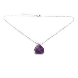 Fashionable purple amethyst raw stone pendant necklace with silver chain on white background
