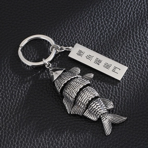 Articulated carp fish keychain in stainless steel with Good Luck tag on black leather