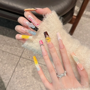 Extra long press-on nails with 3D floral art, colorful gems, and artistic gradients