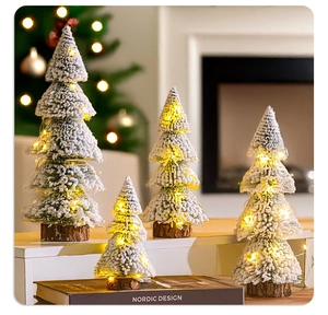 Mini cedar Christmas trees with snow flocking, warm LED lights, and rustic wood bases