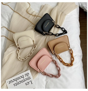 Mini jelly chain crossbody bags in black, white, pink and brown on white fabric