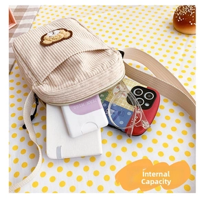 Corduroy bear shoulder bag interior storage capacity showing phone and glasses