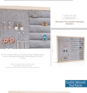 Detail of solid wood jewelry organizer with grey velvet lining and necklace hooks