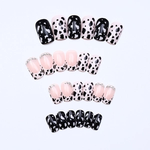 Extra long press-on nails with black cow print and sparkling rhinestones for women
