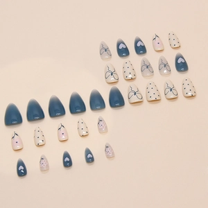 Almond press-on nails set featuring blue and white heart, bow, and polka dot patterns