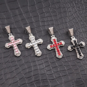 Detailed view of hip hop cross pendants with colorful zircon stones and pavé set crystals