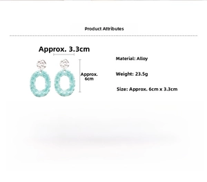 Detail view of oval drop earrings with silver hammered disk and green woven hoop