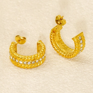 Gold C-shaped hoop earrings with twisted rope texture and inlaid cubic zirconia stones