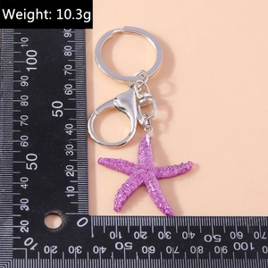 Detail of purple sequin starfish keychain with silver lobster clasp and size reference