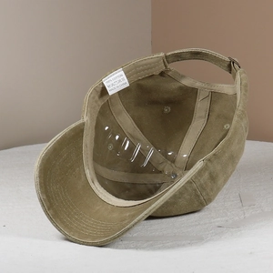 Detailed view of 100% cotton inner lining and wash label of the khaki baseball cap