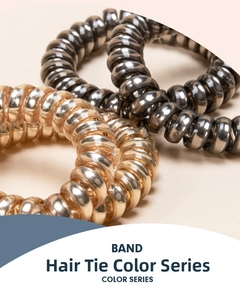 Macro detail of metallic gold and black spiral telephone wire hair bands with glossy finish