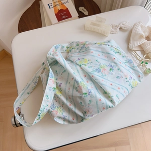 Detail of floral printed cotton tote bag with soft light on a white desk