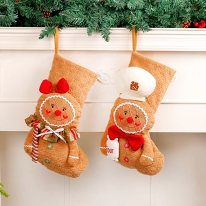 Christmas gingerbread man stockings with waffle texture hanging on a white mantel fireplace