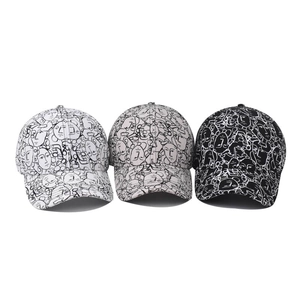 Three cotton baseball caps with abstract face art prints in white, grey, and black