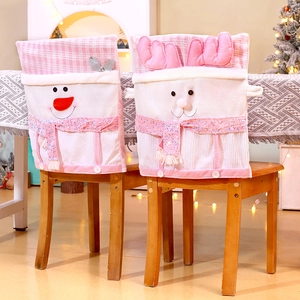 Pink and white Christmas chair covers featuring sequined snowman and elk on wooden chairs