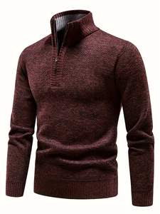 Detail of the dark red knit texture and ribbed cuffs on the half-zip men's sweater