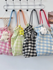 Plaid canvas tote bags in four colors with braided rope handles and plush charms