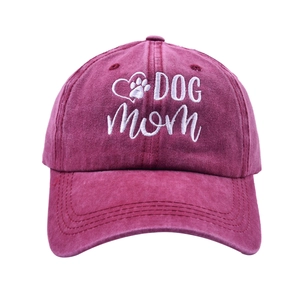Detail of white Dog Mom embroidery and heart paw print on vintage burgundy baseball cap