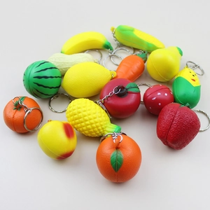 Macro shot of colorful mini fruit keychains featuring strawberry, banana and pineapple