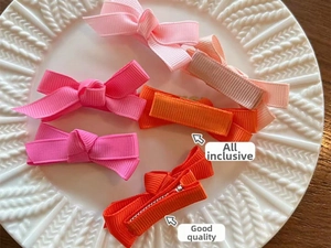 Detailed view of colorful grosgrain ribbon hair bows with safe fabric-wrapped clips