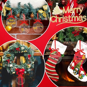 Clear acrylic Christmas round ornament with red ribbon and festive patterns on red background