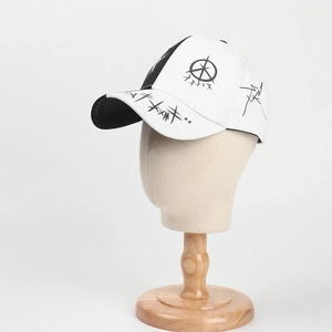 Detailed close-up of a black and white graffiti baseball cap on a mannequin stand