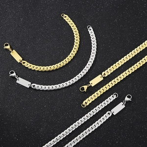 Detail of silver and gold Cuban link bracelets with engravable metal nameplates