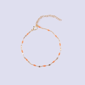 Detail of gold-plated lip chain with orange enamel charms and adjustable lobster clasp