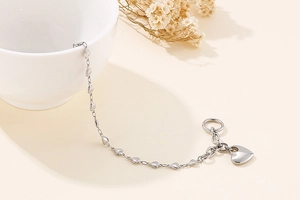 Close-up of silver stainless steel heart pendant necklace with T-bar toggle clasp