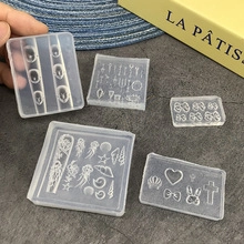 Detailed view of DIY transparent silicone nail art molds with hearts, shells and bows
