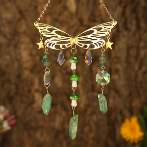 Golden butterfly wind chime with crystal moon, green glass mushroom, and star accents