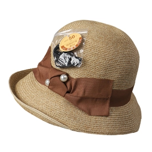 Women's woven straw sun hat with UPF 50+ rating and elegant brown satin bow detail