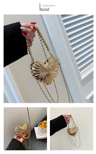 Detailed views of a gold heart-shaped metal handbag with radiating textures and bead chain