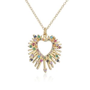 Close-up of 18K gold plated heart necklace with colorful gemstones and sunburst detail