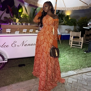 Detail of elegant orange swirl print on a one-shoulder bodycon maxi dress at night