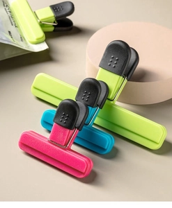 Detail of colorful plastic food sealing clips in pink blue and green for snack bags