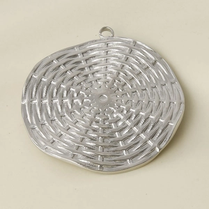 Detailed close-up of a silver stainless steel round pendant with woven basket texture