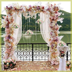 Outdoor wedding metal hoop decor featuring silk flowers, crystal beads, and lake view