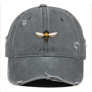 Dark gray washed cotton baseball cap with bee embroidery and distressed ripped details
