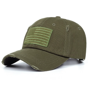 Detailed close-up of olive green vintage distressed baseball cap with flag patch embroidery
