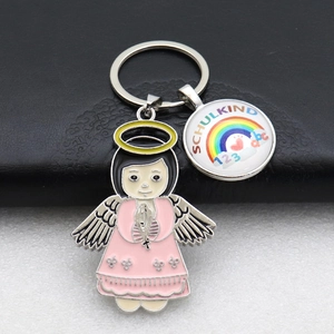 Detail of metal keychain with pink angel girl and Schulkind rainbow glass charm