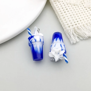 Close-up of blue and white gradient resin beverage cup pendants with straws for DIY jewelry