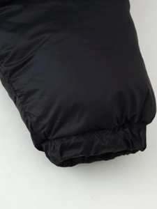 Detail view of elastic cuffs on a black puffer jacket with waterproof nylon fabric
