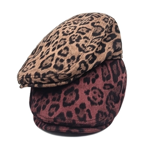 Close-up of leopard print beret hats in brown and red with soft suede texture