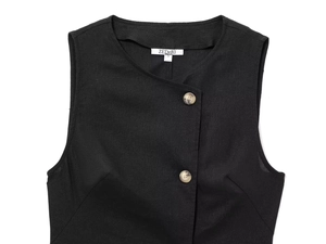 Detail of black linen vest showing texture and marble-patterned buttons on the front